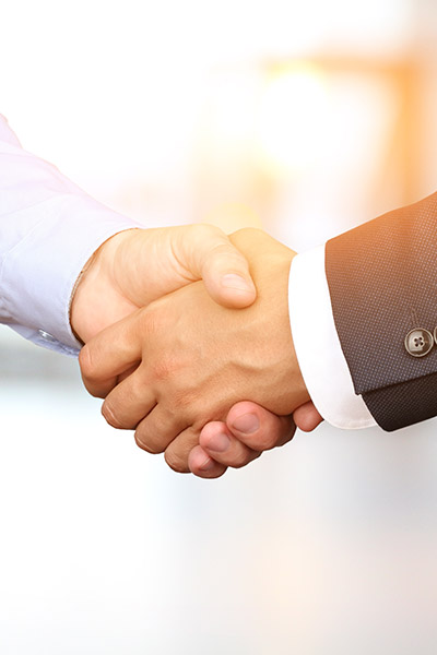 Image of a firm handshake between two colleagues in office. Image of a firm handshake between two colleagues in office.